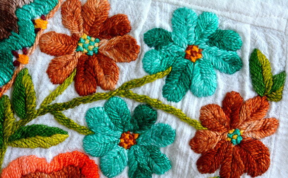 Embroidered flowers on natural white fabric, Serbian folk embroidery.