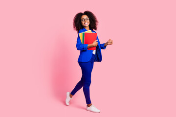 Photo of lovely charming girl wear trendy blue clothes go school carry books isolated on pink color background