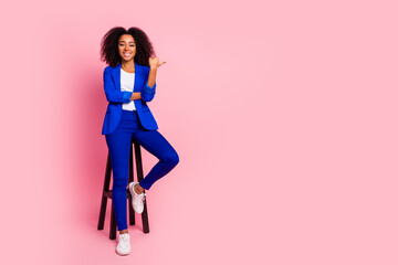 Photo of adorable lovely girl wear trendy blue clothes sit wooden stool empty space isolated on pink color background