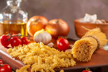 Pasta, table with pasta, ingredients and utensils, selective focus.