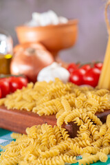 Pasta, table with pasta, ingredients and utensils, selective focus.