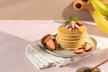 Delicious Pancakes with Strawberries and Almonds beautifully arranged on a Plate