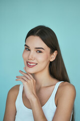 Natural Beauty Perfect Skin Concept, Skincare Routine Inspiration. Fresh-Faced Young Woman Smiling, Healthy Complexion Against A Clean, Blue Background.