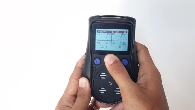 Using a portable gas detector to monitor the composition of the surrounding air or toxic gases (on a white background). Industrial action.