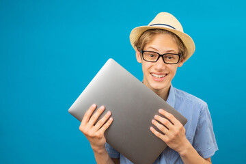 Waist up happy portrait view of the funny businessman teen holding laptop in hands.