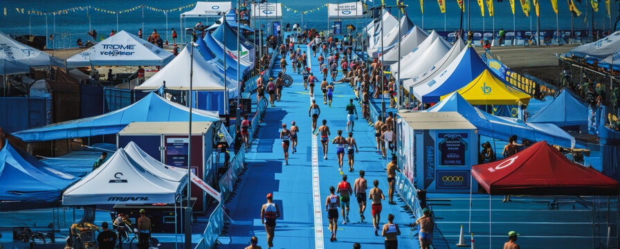 Athletes running on blue course at triathlon event