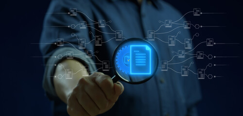 Document management system and process automation concept. Quality business service. Businessman holding magnifying glass to show document signs with cogwheel gear icon.