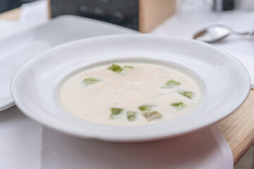 Creamy White Soup With Green Garnish Served in White Bowl