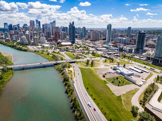 Aerial street view downtown skyline with river and bridges overlooking winding roads with traffic in Calgary Alberta Canada.