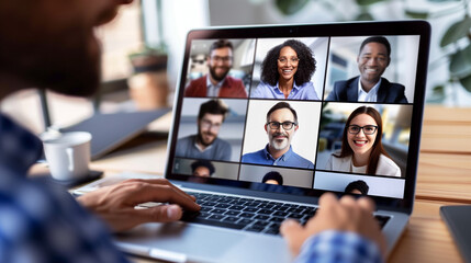 Online meeting with colleagues' faces in a grid on a laptop, captured in a clean, light workspace.

