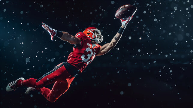 American football player leaps to catch ball at night on stadium field