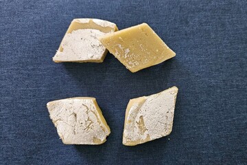 Sweet dessert, Milk based Sweet calls barfi, four pieces of sweet barfi and filigree foil sheet of Silver on it. Wow yummy Sweet Dessert. Usually eaten after the meals. 