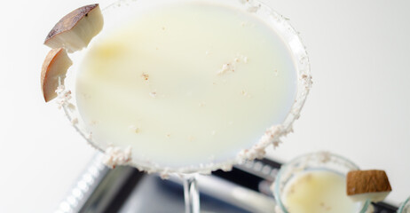 A martini glass with a garnish of coconut flakes on top