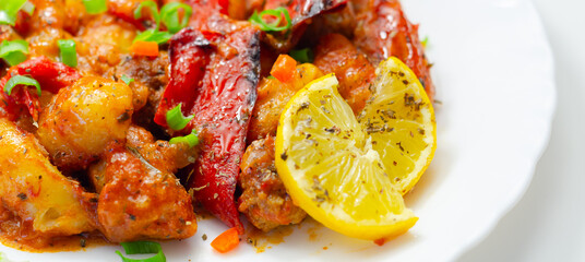 A plate of food with a lot of red peppers and onions