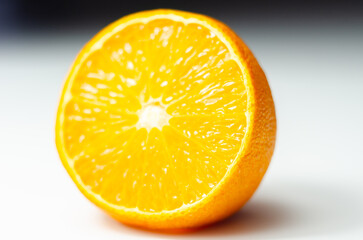 A half of orange with the white part of the fruit visible