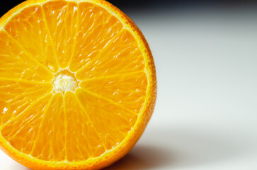 A half of orange with the white part of the fruit visible