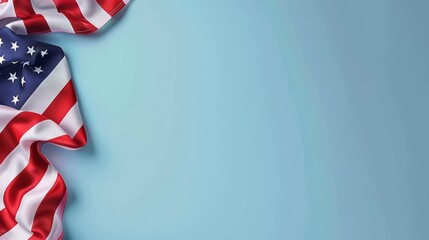 Fototapeta premium A folded American flag on a blue background, with copy space for text. Perfect for patriotic designs.