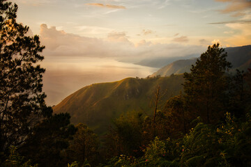 This captivating photo captures a golden sunrise over Lake Toba in Sumatra, Indonesia. The serene waters and lush hills create a tranquil scene, perfect for nature and travel enthusiasts seeking a bre
