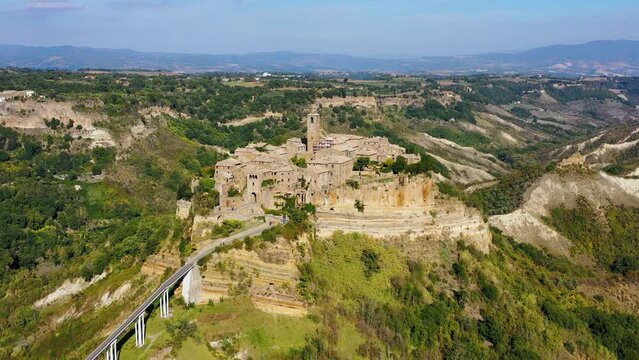 The famous Civita di Bagnoregio on a sunny day. Province of Viterbo, Lazio, Italy. Medieval town on the mountain, Civita di Bagnoregio, popular touristic stop at Tuscany, Italy.
