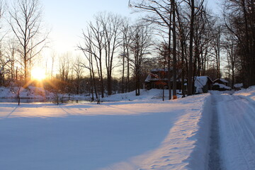 winter sunset at cabin in the woods