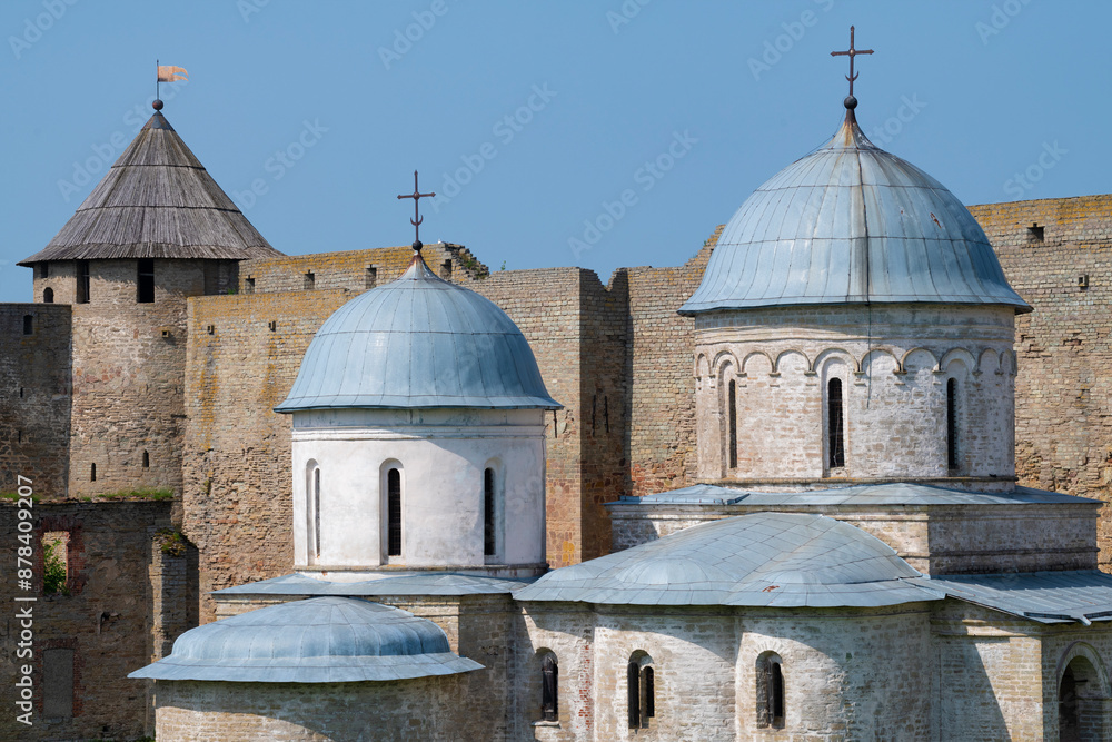 Wall mural Domes of the ancient Church of the Assumption of the Blessed Virgin Mary (1558) on a June day. Ivangorod Fortress, Leningrad Region. Russia