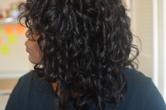Shiny healthy curly long black hair, thick black hair that has been curled, healthy black 2c hair