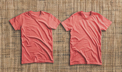 Two blank t-shirts in coral, front view, laid flat on a textured woven fabric background. The intricate texture adds a handcrafted feel, suitable for artisanal branding themes.