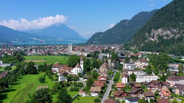 Aerial view over the city of Interlaken in Switzerland. Beautiful view of Interlaken town, Eiger, Monch and Jungfrau mountains and of Lake Thun and Brienz. Interlaken, Bernese Oberland, Switzerland.