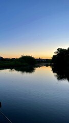 A landscape with a view of the river and the sunset