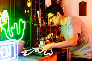 Focused man with signboard and gas pump