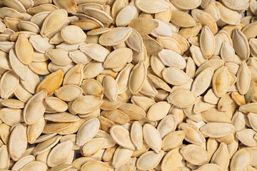 Close-up of unpeeled pumpkin seeds from above.