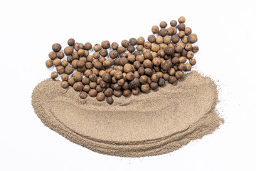 Ground black pepper and peppercorns close-up.
