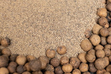 Ground black pepper and peppercorns close-up, top view