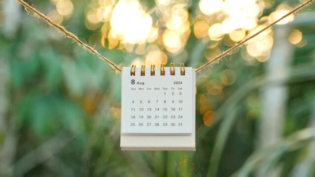 Desk calendar for the month of August 2024 hanging on a rope. bokeh background. August 17, Indonesian Independent Day