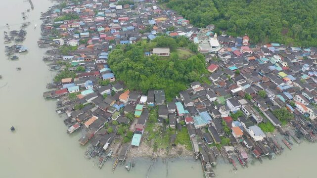 Aerial view of fishing trap net in canel with fisherman urban city village town houses, lake or river. Nature landscape fisheries and fishing tools at Pak Pha, Songkhla, Thailand. Aquaculture farming