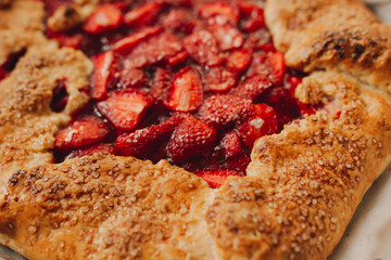 pie with strawberries on a plate, dark background, closeup
