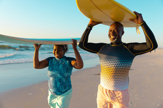Senior African American couple enjoys a beach day, with copy space