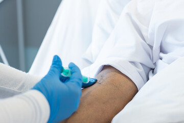 Nurse administers an injection to a patient in a hospital