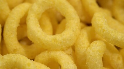 Crispy ring snacks isolated on white background. Corn onion rings in bowl isolated on white background. Crispy onion rings, isolated on white background. Snacks for watching movies.