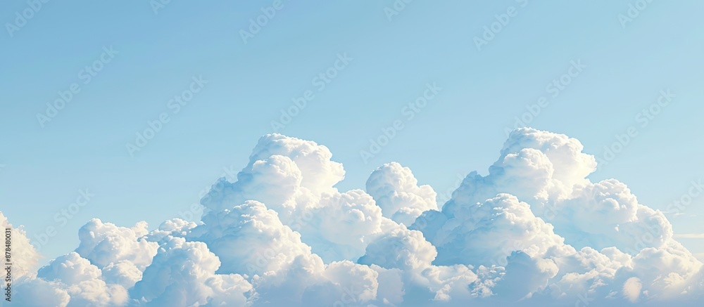Poster Daytime scene showing white clouds set against a clear blue sky background with ample copy space image available.