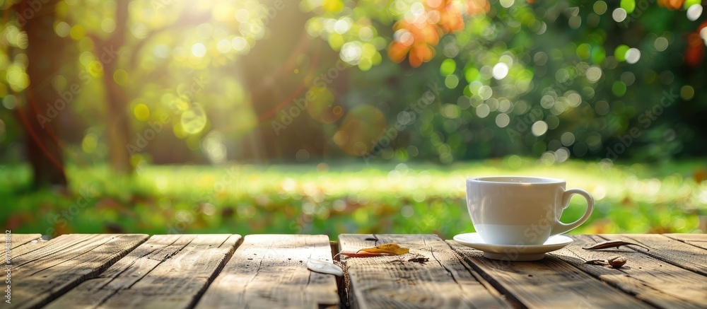 Poster coffee cup on wooden table outdoors with a natural backdrop, ideal for adding text. incorporating a 