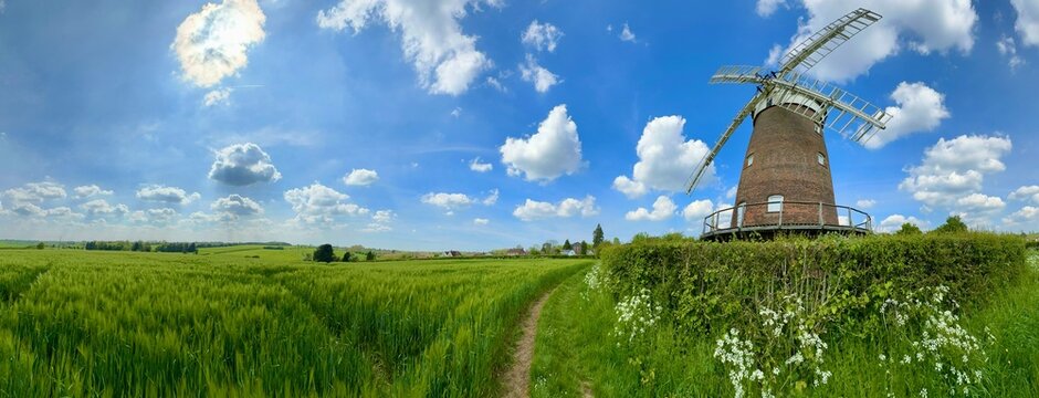 A panoramic view of an historic windmill over looking farmland in rural England. 