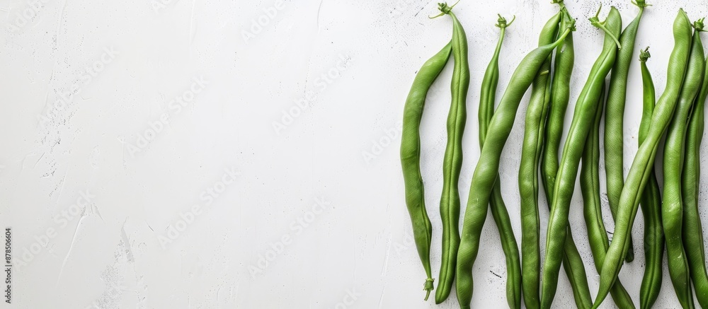 Poster green beans arranged neatly on a white backdrop, with a space for text or graphics included in the i