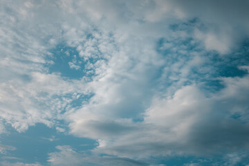The sky is blue with a few clouds scattered throughout. The clouds are white and fluffy, giving the sky a peaceful and serene appearance