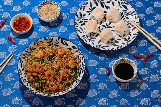 Top view of Chinese cuisine featuring noodles and dumplings