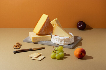 Assorted gourmet cheeses on a table with fruits and nuts