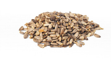 Silybum marianum herb seeds.Seeds of a milk thistle on white background.Alternative medicine concept on a white wooden table, selective focus.