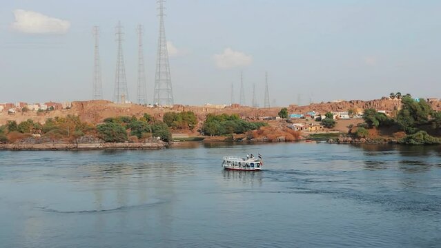 Traditional  boat on the Nile river with tourists in Aswan , Egypt