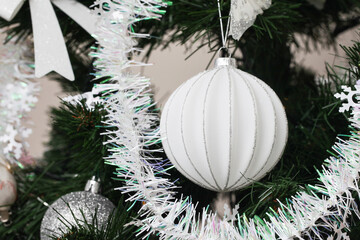 White bauble on the Christmas tree. Elegant ornament adds a touch of festive charm to any holiday...