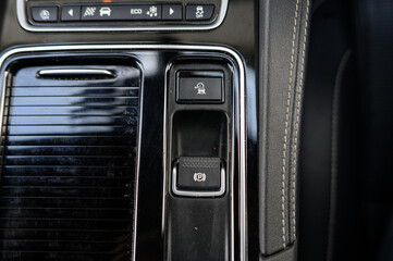 Fototapeta premium Close-Up of Electronic Parking Brake Control: Modern Vehicle Interior with High-Tech Parking Feature
